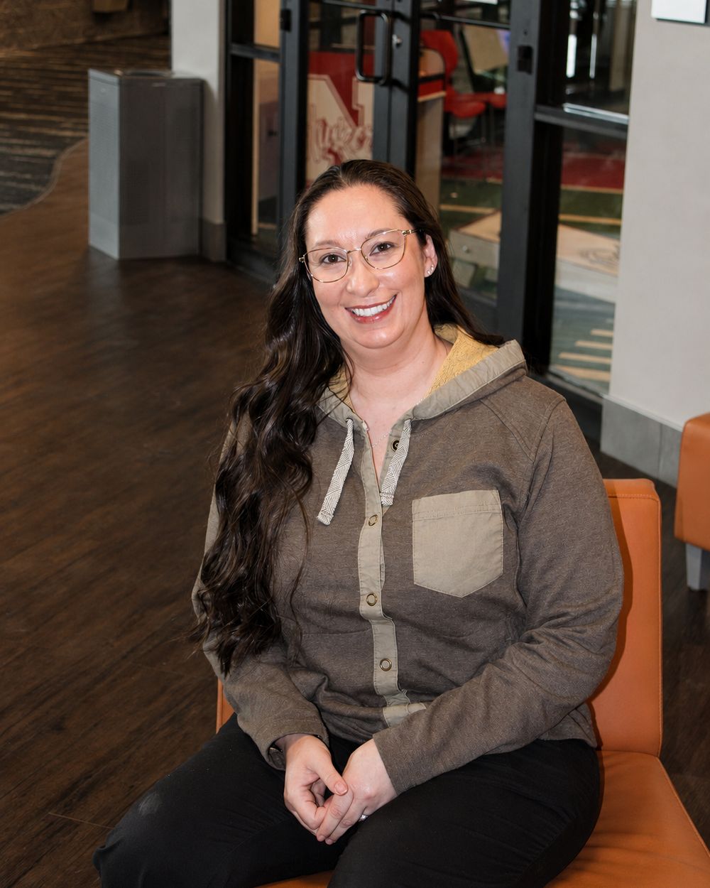 A Webb Eyecare team member wearing frames from the collection.