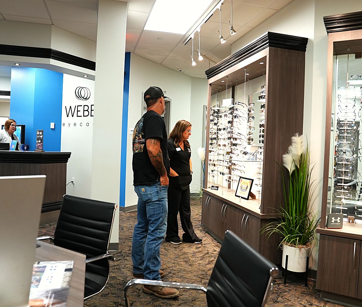 A patient browsing the frame boards with a Webb Eyecare optician in Scottsbluff.