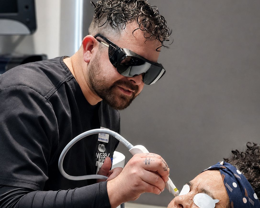 A Webb Eyecare team member performing an in-office dry eye treatment.