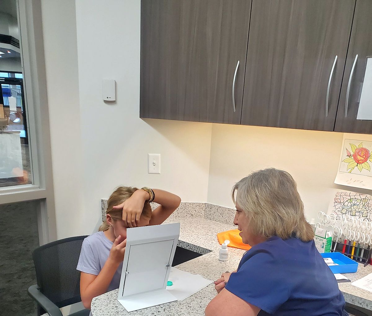 A Webb Eyecare specialist working one-on-one with a young patient.