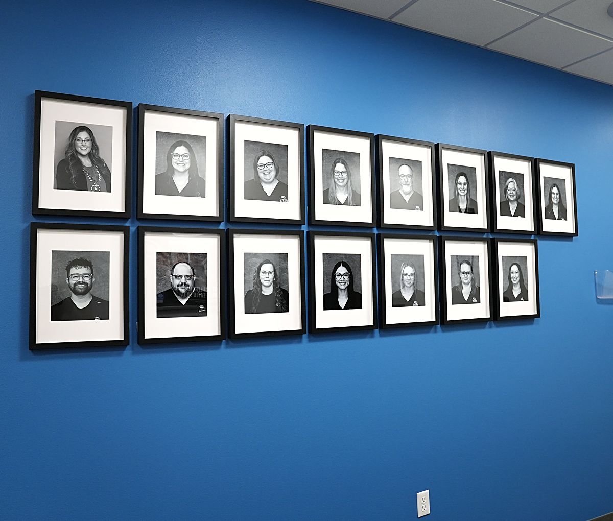 The Webb Eyecare staff portrait wall in the Scottsbluff clinic.